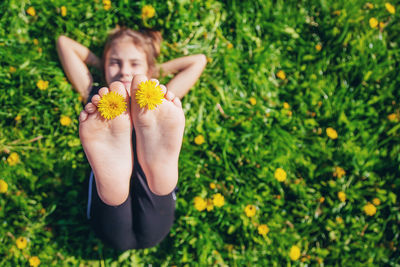 Girl holding flower in feet fingers