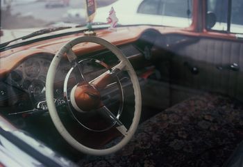 Steering wheel seen through glass window
