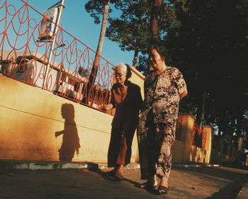 Full length of woman standing by railing