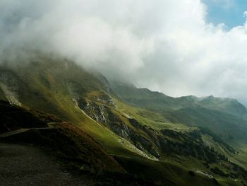 Scenic view of mountains against cloudy sky