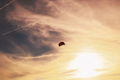 Low angle view of silhouette bird flying against sky