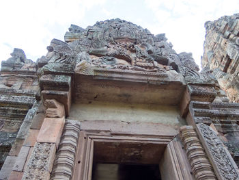 Low angle view of statue against historic building