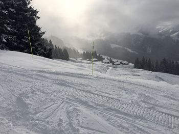 Scenic view of snow covered field against sky