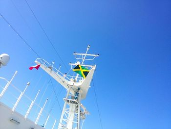 Low angle view of ski lift against clear blue sky