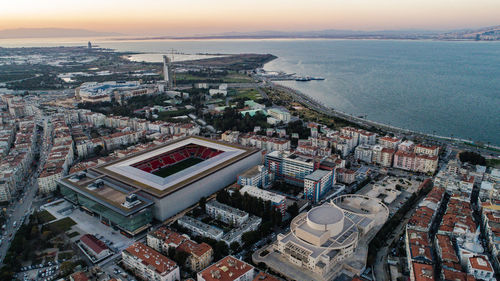 High angle view of townscape by sea against sky