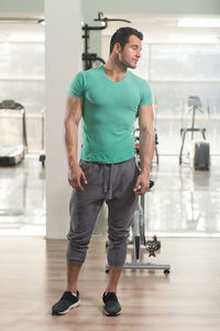 Muscular man standing in gym