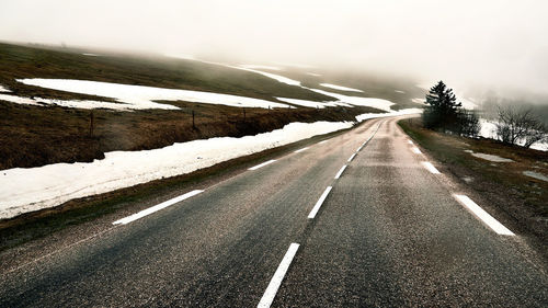 Snow covered landscape against sky