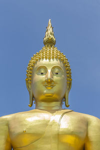 Low angle view of statue against clear blue sky