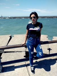 Portrait of boy wearing sunglasses against sea