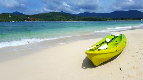 View of beach against cloudy sky