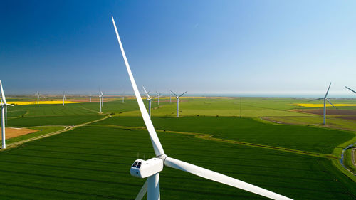 Windmill on field against sky