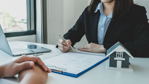 Midsection of woman using mobile phone