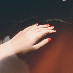 Close-up of woman hand with red light