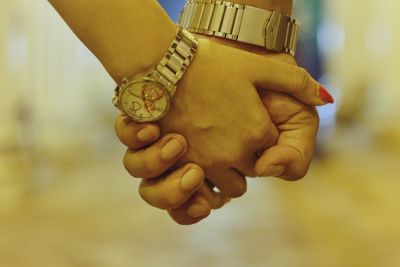 Close-up of couple holding hands