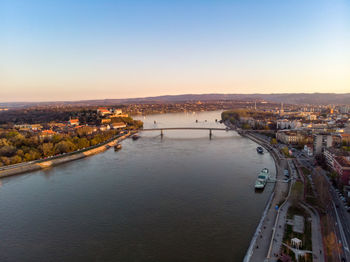 High angle view of river amidst buildings in city against sky