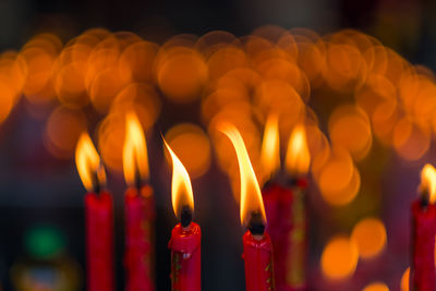 Close-up of lit candles in temple