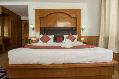 Rear view of person relaxing on bed at home