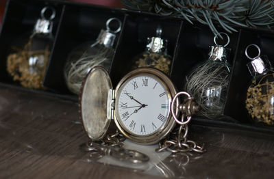 Close-up of pocket watch on table