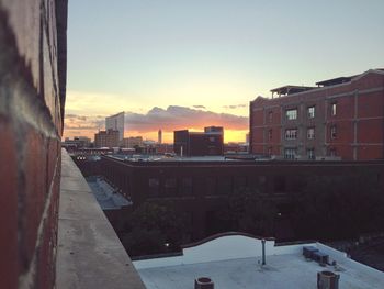 Buildings in city at sunset