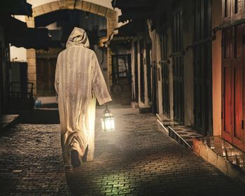 Rear view of man walking in a medina 