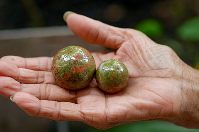 Close-up of hand holding sphere shape objects