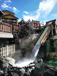 Panoramic view of buildings and rocks against sky