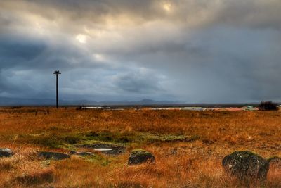 Countryside landscape against cloudy sky