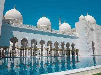 View of mosque against clear blue sky