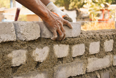 Low angle view of hand working at construction site