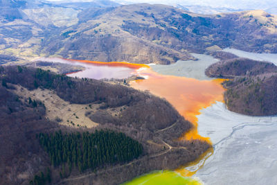 Aerial view of mining settling basin and lime supply. colorful polluted mine water geamana, romania