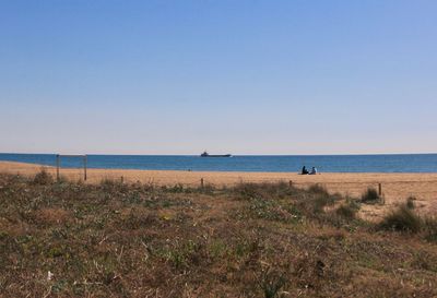 Scenic view of beach against clear sky