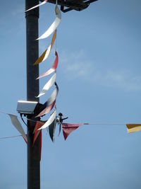 Low angle view of pole against blue sky