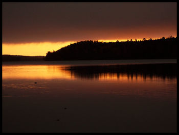 Scenic view of lake at sunset