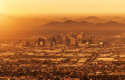 Aerial view of city at sunset