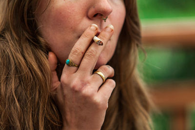 Close-up portrait of woman with hands