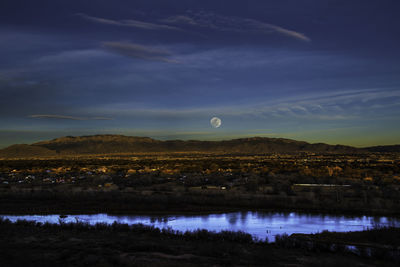 Scenic view of lake against sky at night