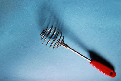 High angle view of umbrella on table against blue background