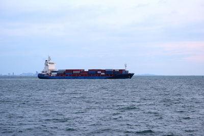 Ship sailing on sea against sky