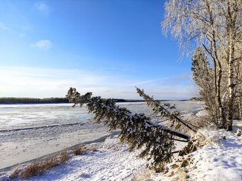 Scenic view of snow covered land against sky