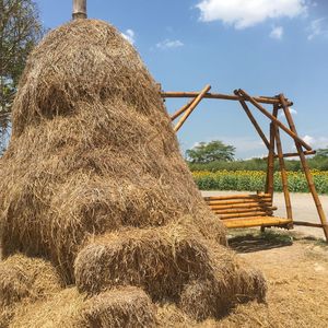 Hay bales on field against sky