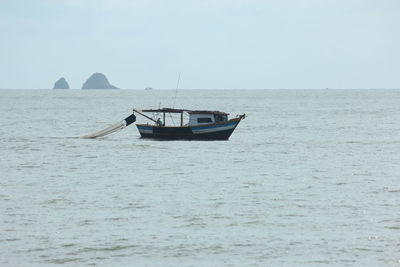 Boat in sea against clear sky