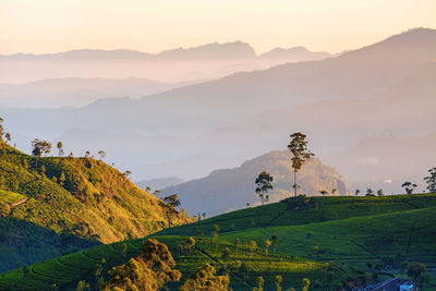 Scenic view of silhouette mountains against sky at sunset