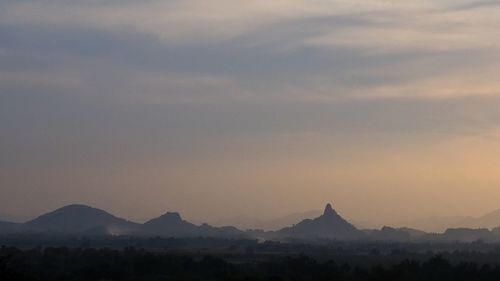 Scenic view of silhouette mountains against sky during sunset