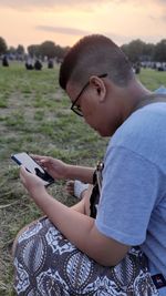 Cropped hand of woman standing on field