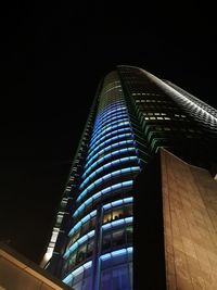 Low angle view of illuminated building against sky at night