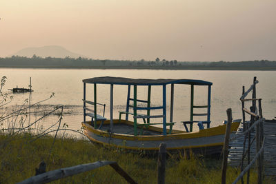 Scenic view of lake against clear sky at sunset