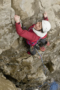 Female climber climbing sea cliff in swanage / england