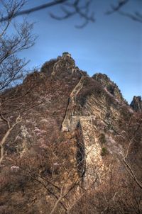 Low angle view of rock formation on mountain against sky
