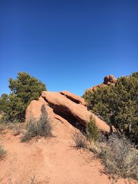 Scenic view of rocky landscape against clear blue sky