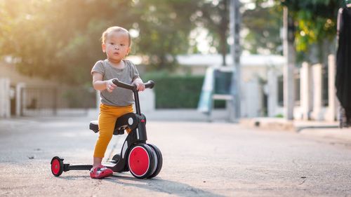 Boy riding toy in city